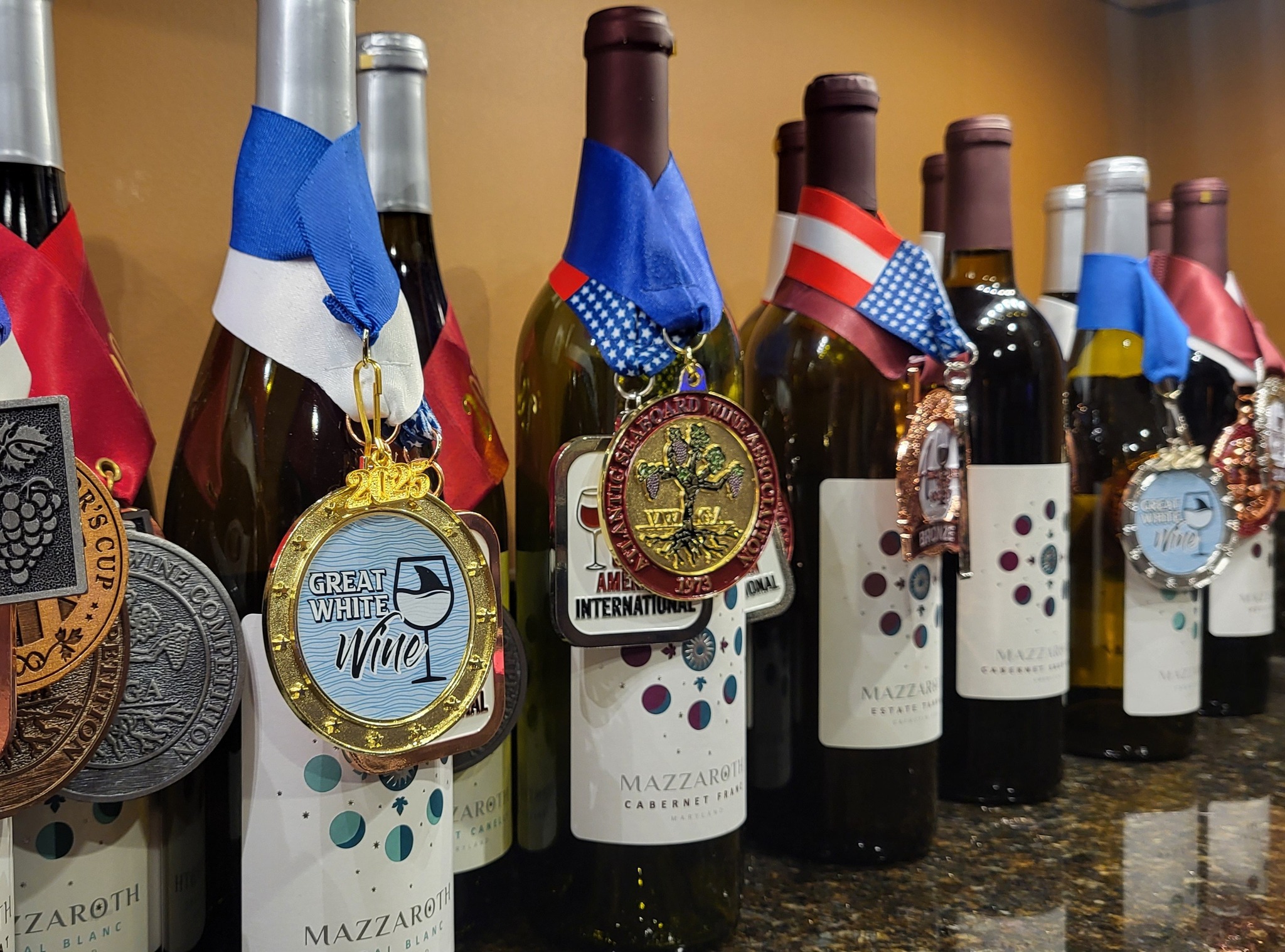 Wine bottles with awards displayed. 