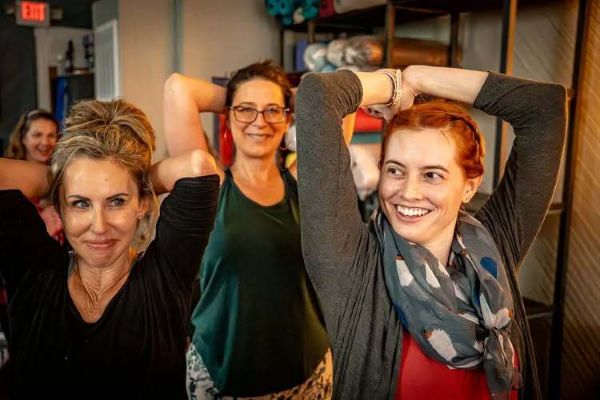 A group of women practicing yoga in the Roots and River yoga studio in Brunswick, MD.