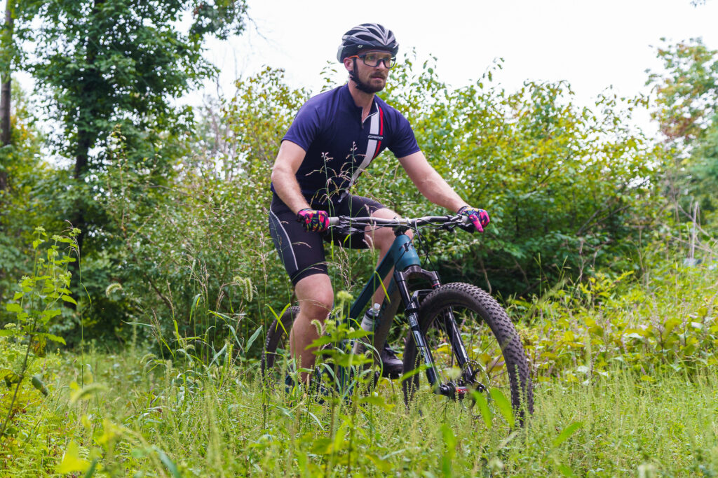 man riding a mountain bike on trail