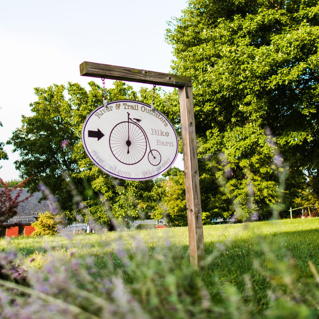 river trail outfitters sign on a post